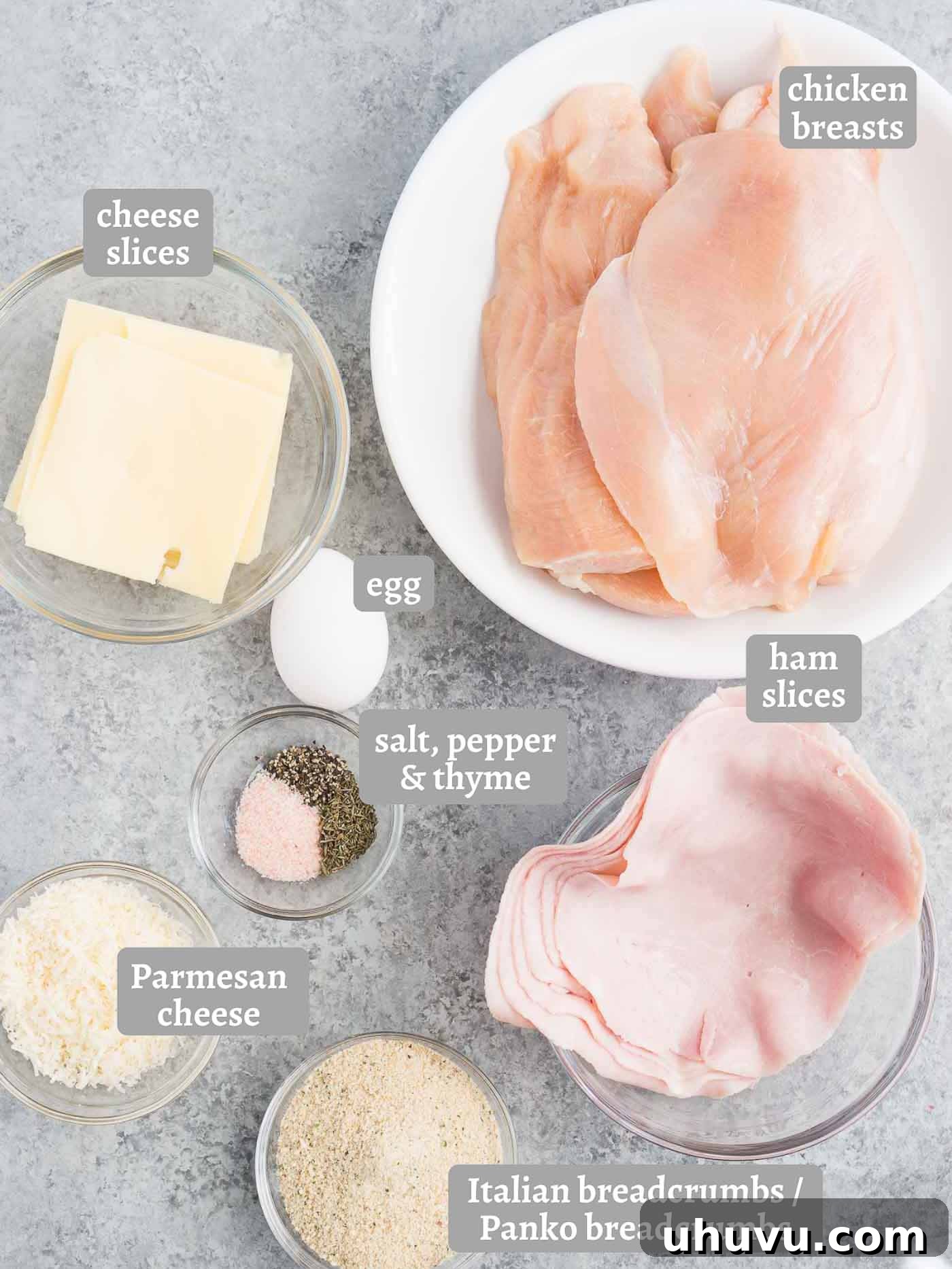 Individual ingredients for chicken cordon bleu laid out on a table