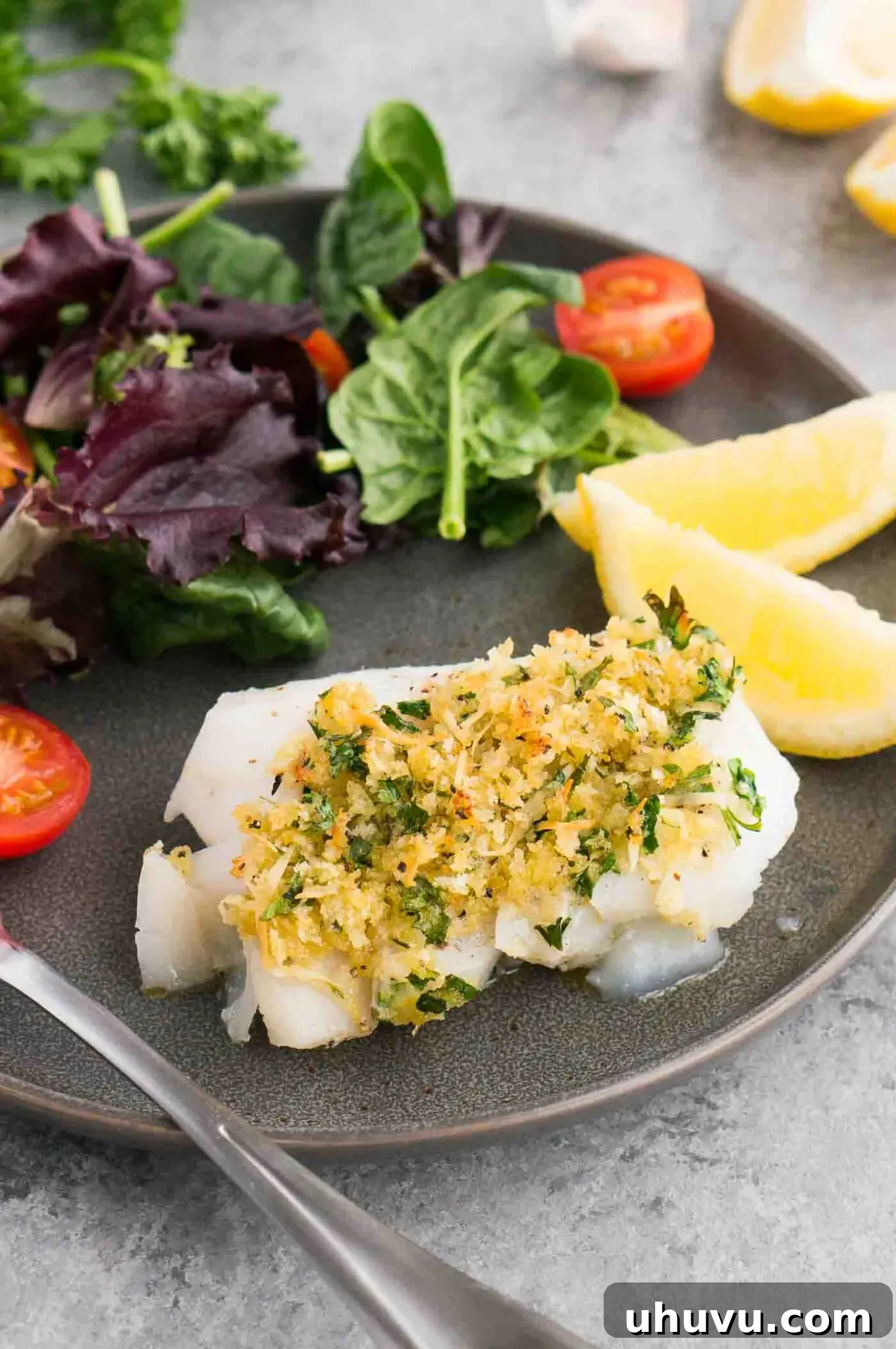 oven baked cod with gremolata on a plate with salad