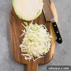 shredded cabbage on a cutting board and a knife