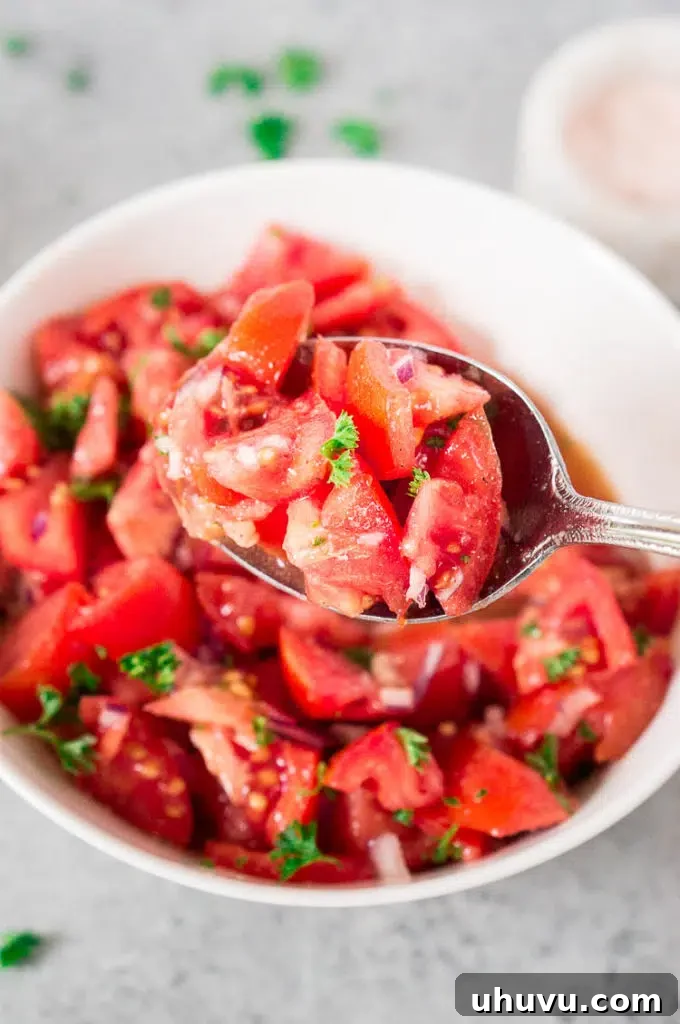 Close up shot of a healthy tomato salad with olive oil dressing