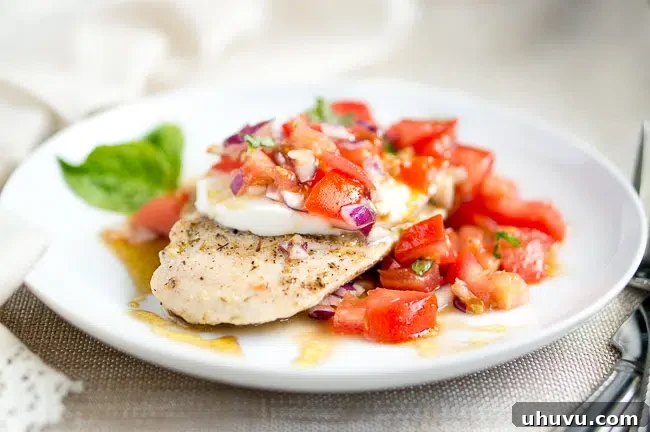 Juicy Grilled Chicken Caprese with fresh tomato and mozzarella topping