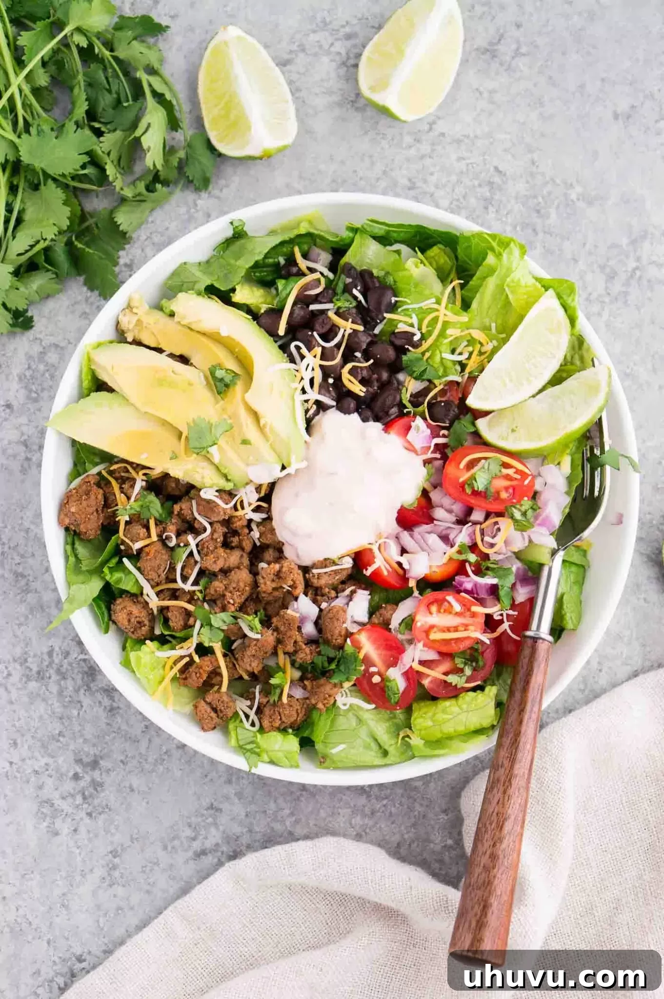 Taco salad and dressing in a bowl from above