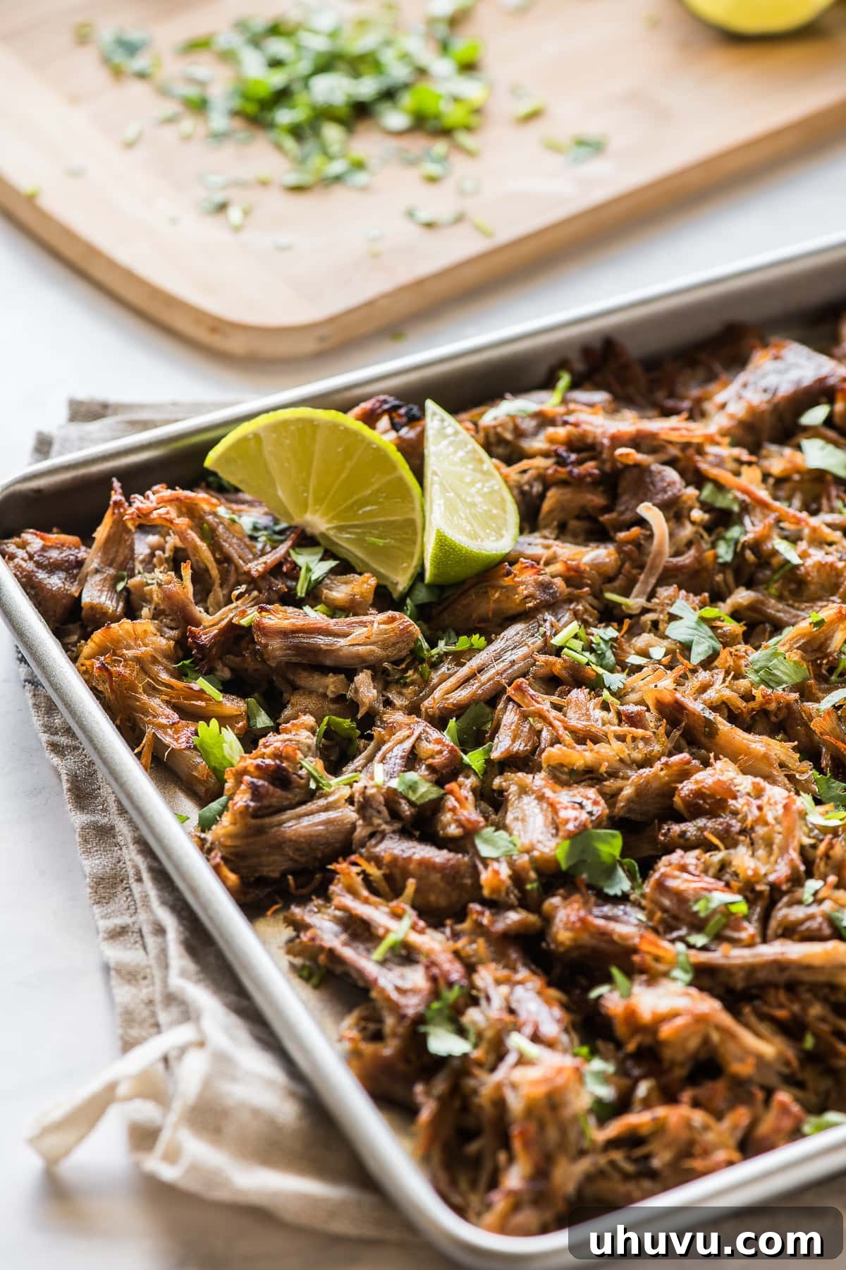 Lightning-Fast Crispy Carnitas 7 Crispy pressure cooker carnitas topped with cilantro on a baking sheet.
