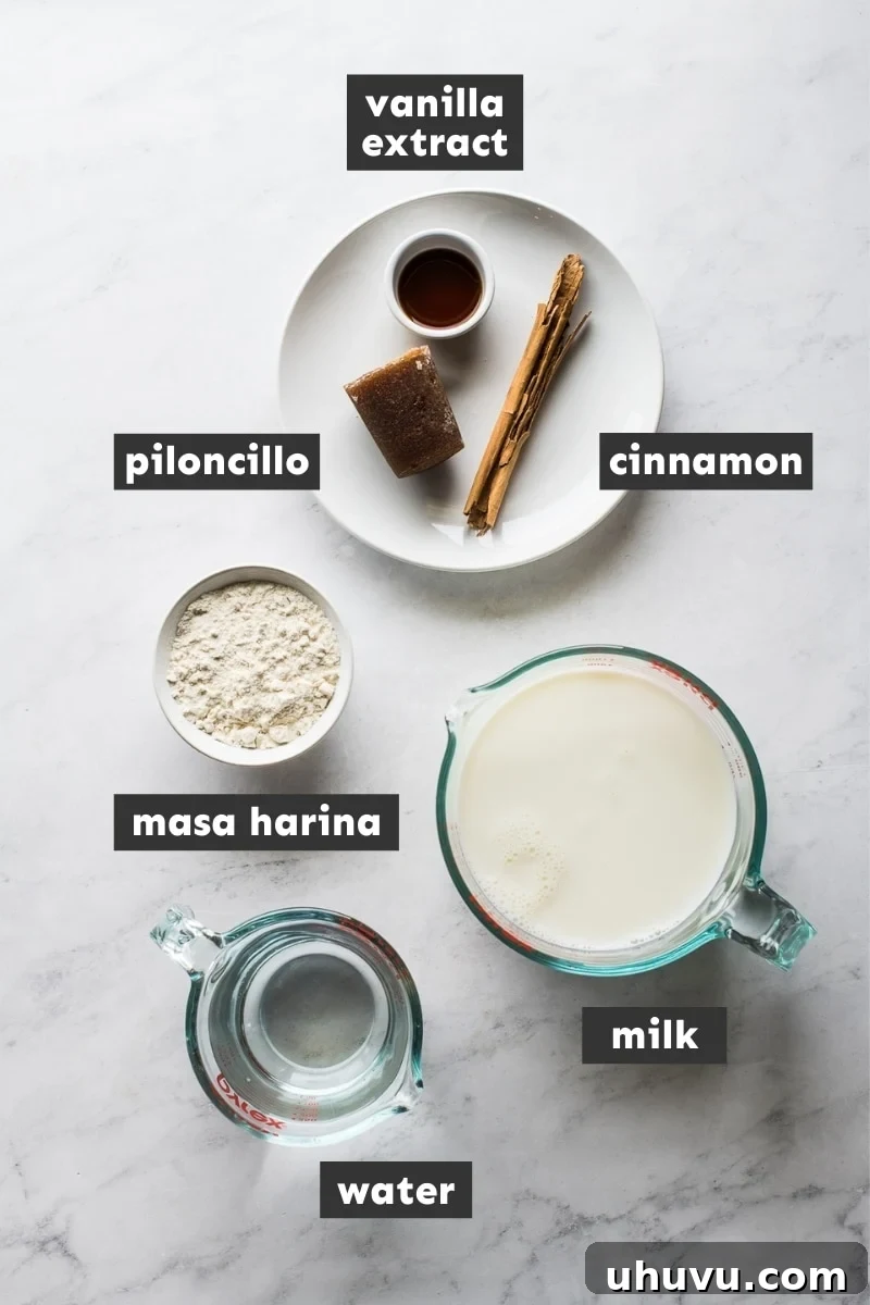 The Comforting Warmth of Mexican Atole 3 A vibrant flat lay image showcasing the essential ingredients for making Mexican atole: a jug of milk, a piloncillo cone, a cinnamon stick, masa harina, and vanilla extract.