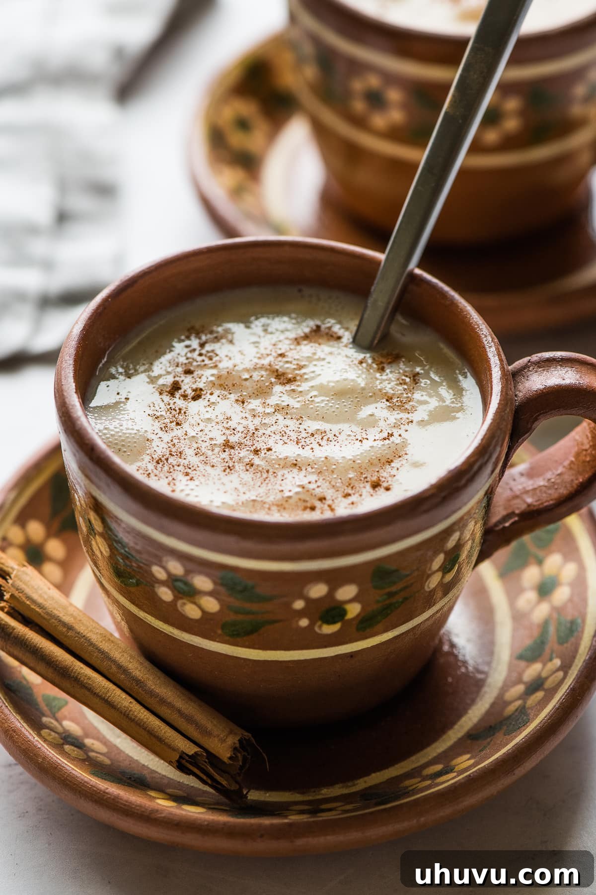 The Comforting Warmth of Mexican Atole 9 A rustic clay mug filled with steaming, creamy Mexican atole, ready to be savored.