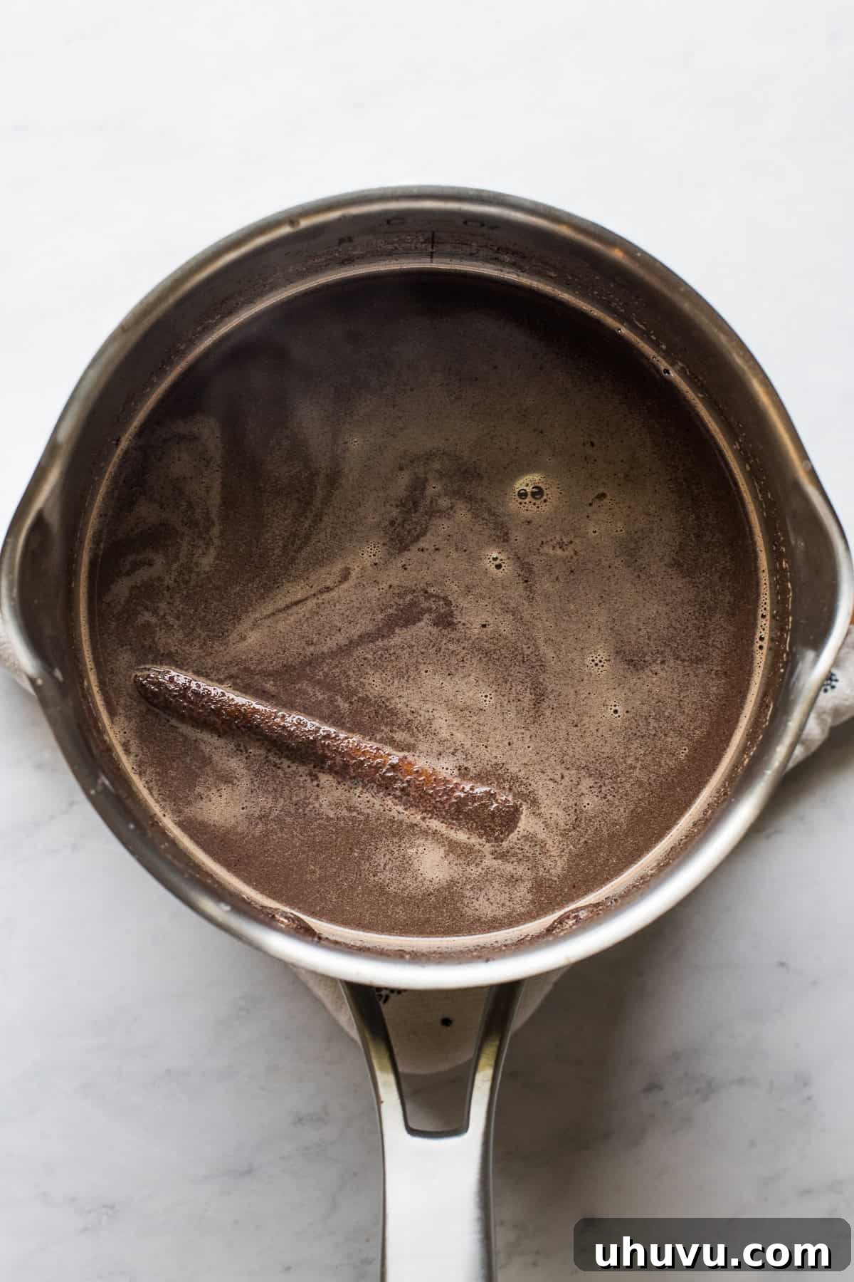 Velvet Corn Chocolate 4 Milk and Mexican chocolate mixture heating in a saucepan until completely dissolved.