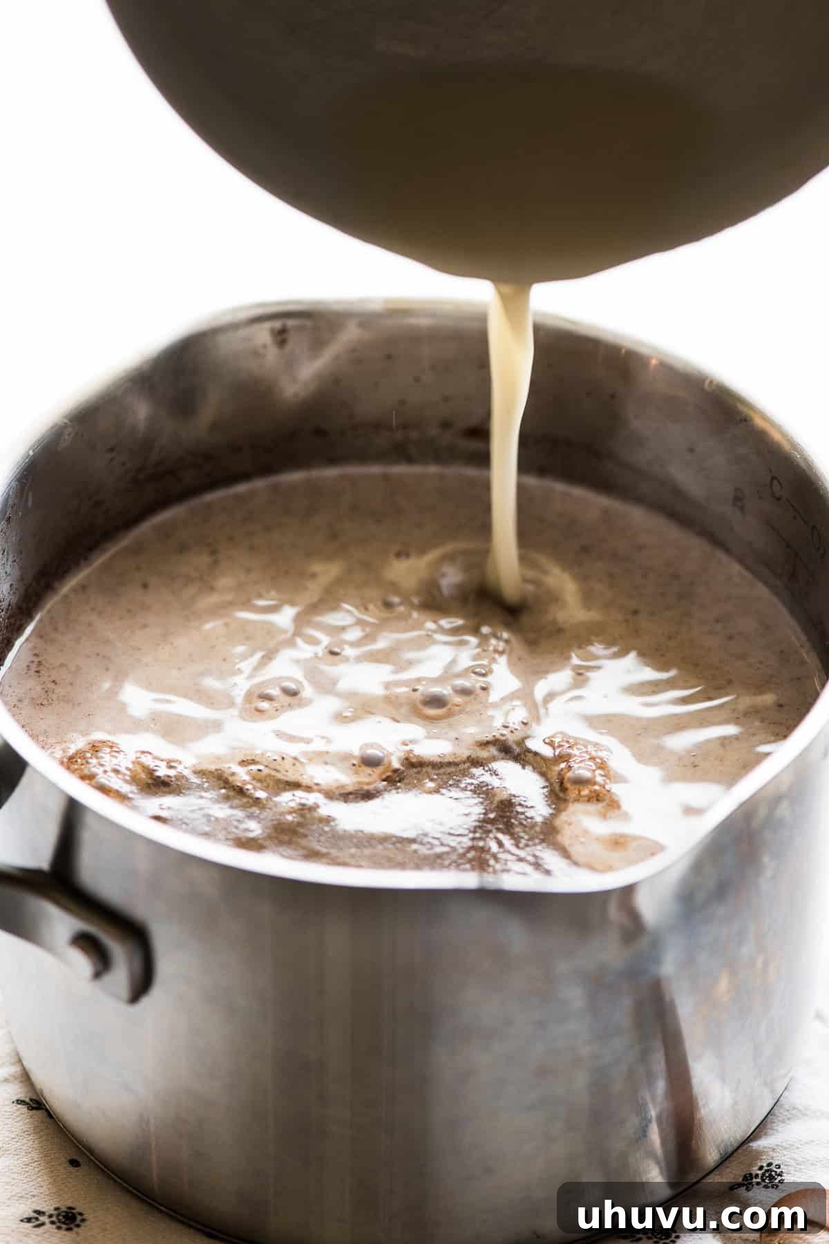 Velvet Corn Chocolate 6 The masa harina mixture being poured into the saucepan of the chocolate mixture.