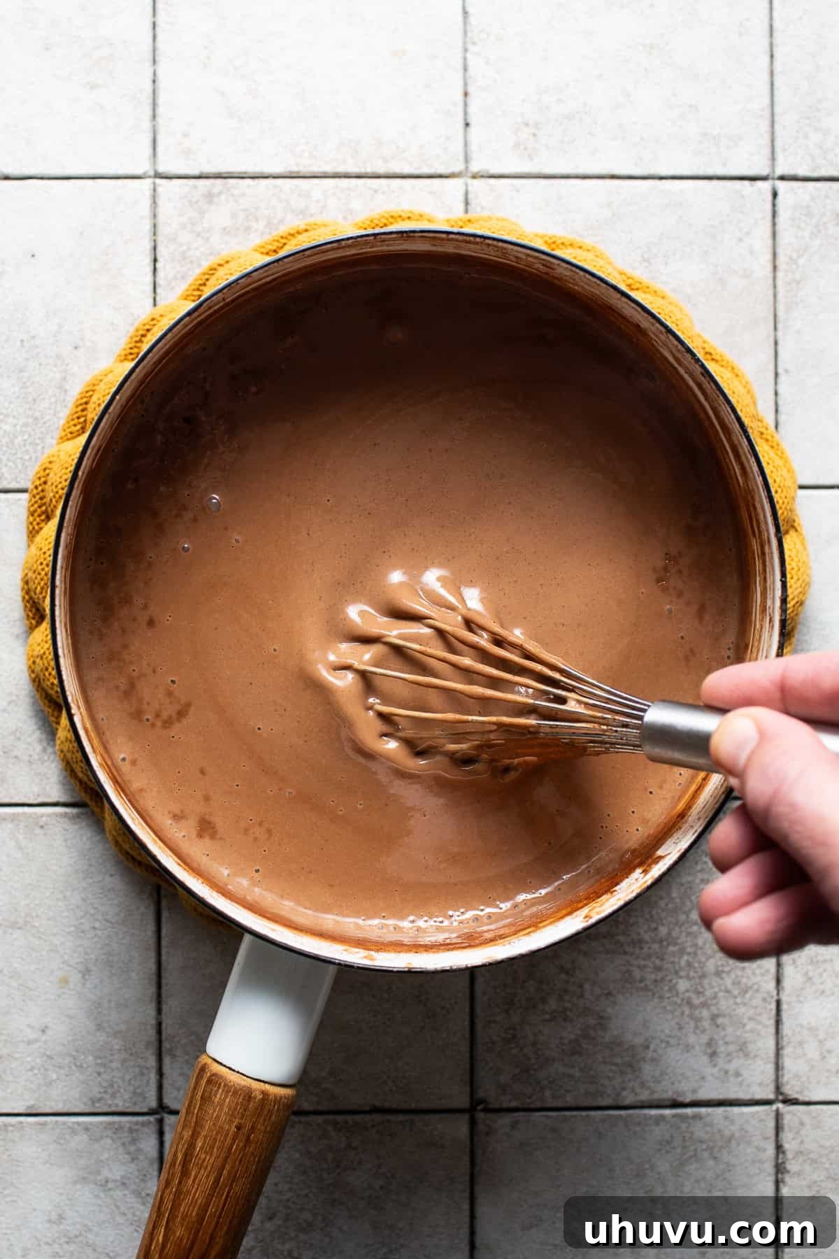 Velvet Corn Chocolate 7 Thick champurrado being whisked together in a saucepan.