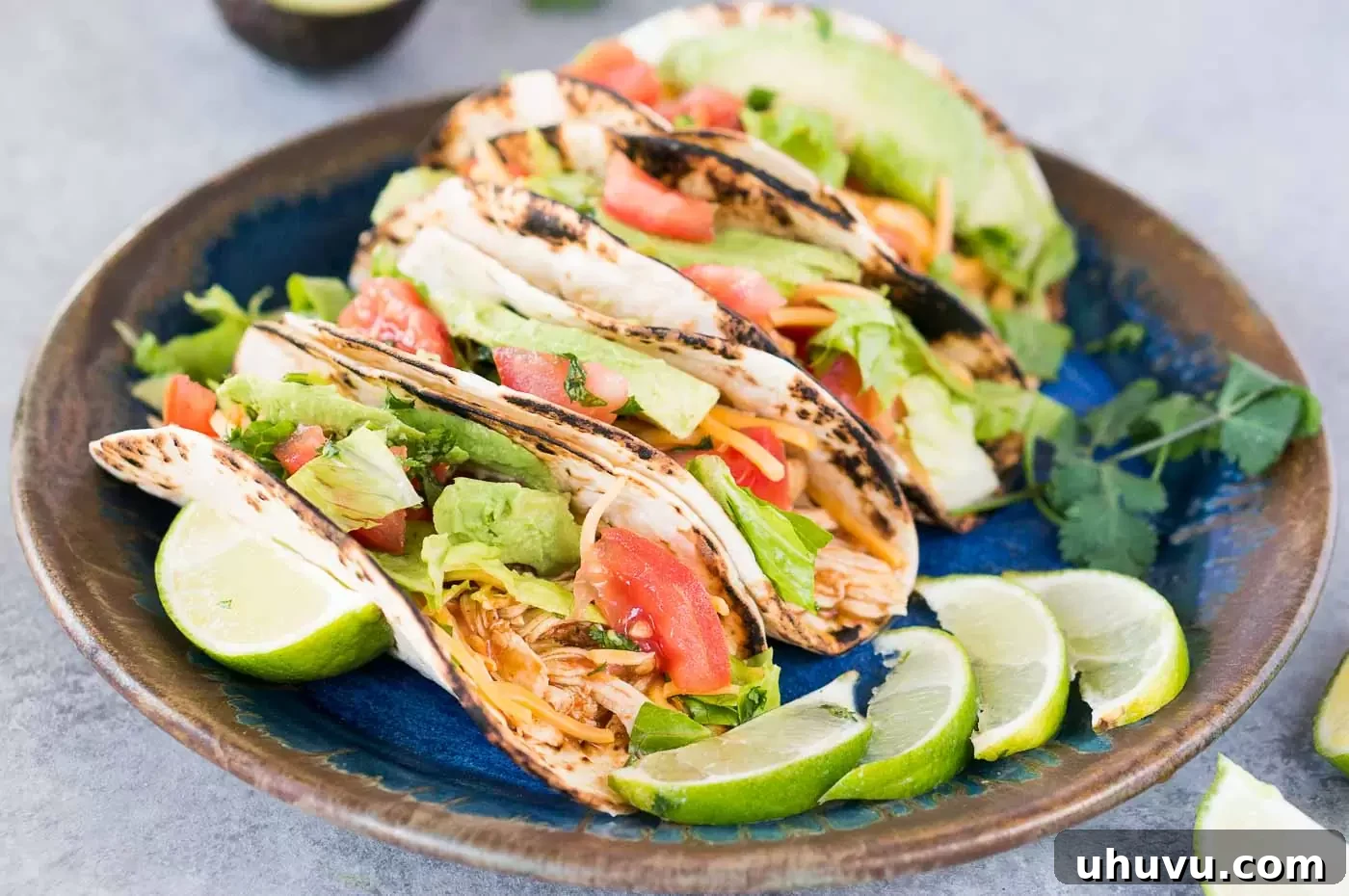 chicken tacos with various toppings arranged on a platter
