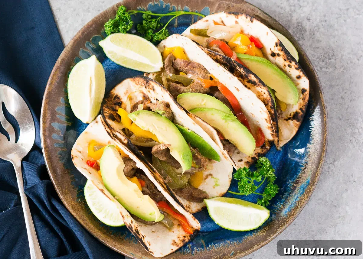 close up image of steak fajitas on a platter
