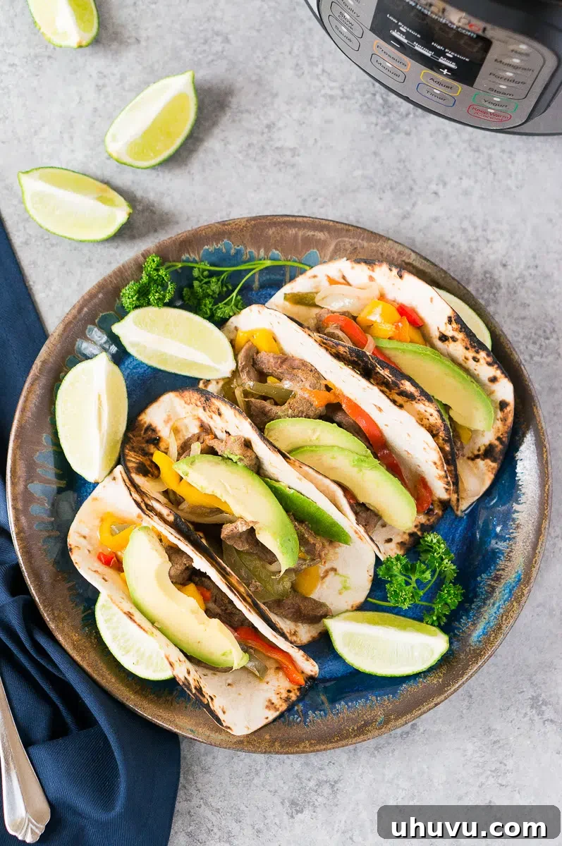 steak fajitas on a plate next to instant pot
