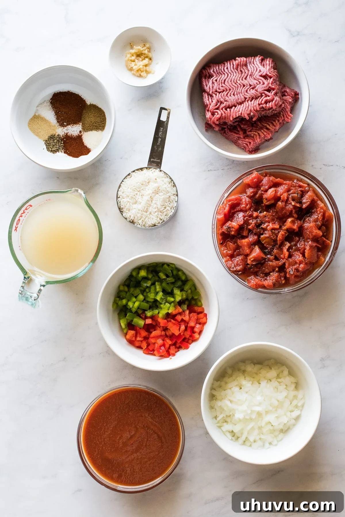 Hearty Bell Pepper and Beef Rice Soup 3 Various ingredients laid out for making stuffed pepper soup, including bell peppers, ground beef, tomatoes, and spices.