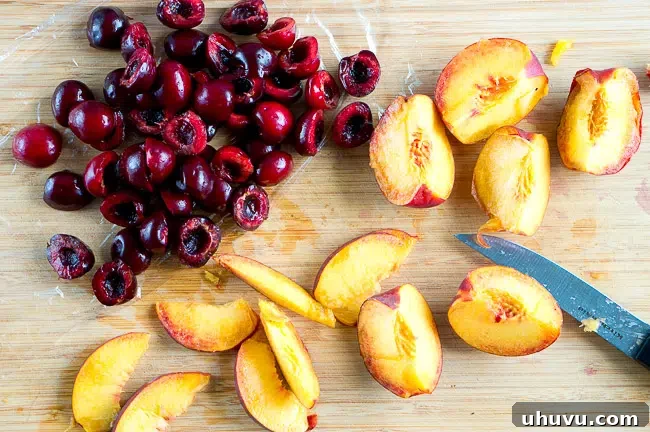 Preparing the cake pan with butter, sugar, peaches, and cherries for an upside-down cake.