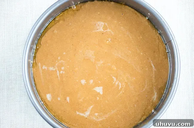 Smooth cake batter ready to be poured over the fruit in the cake pan.