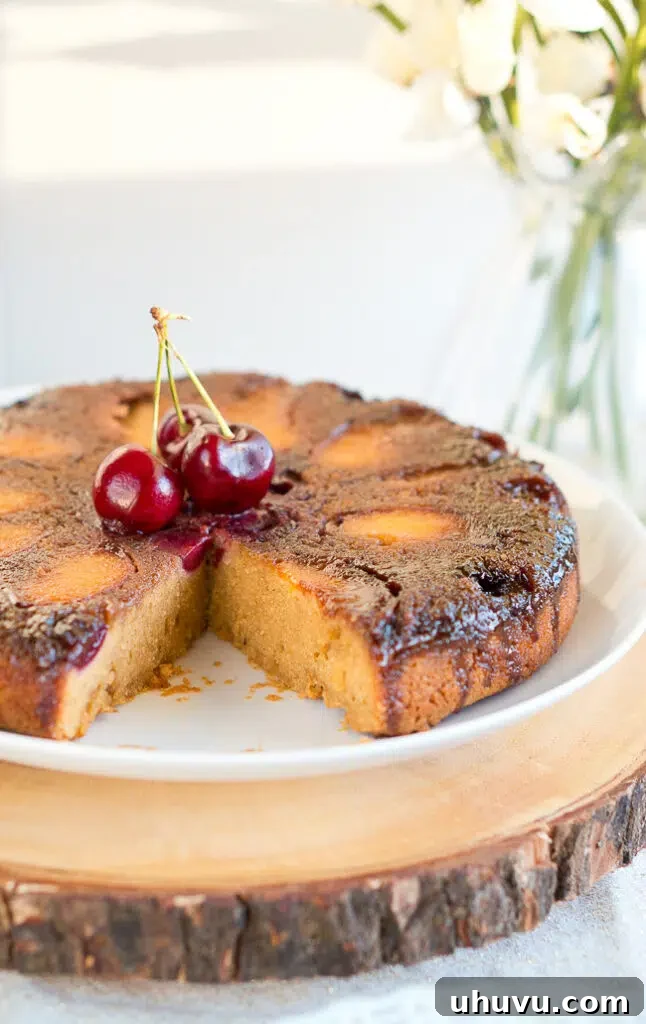 Overhead shot of the full Peach Cherry Upside Down Cake on a table.