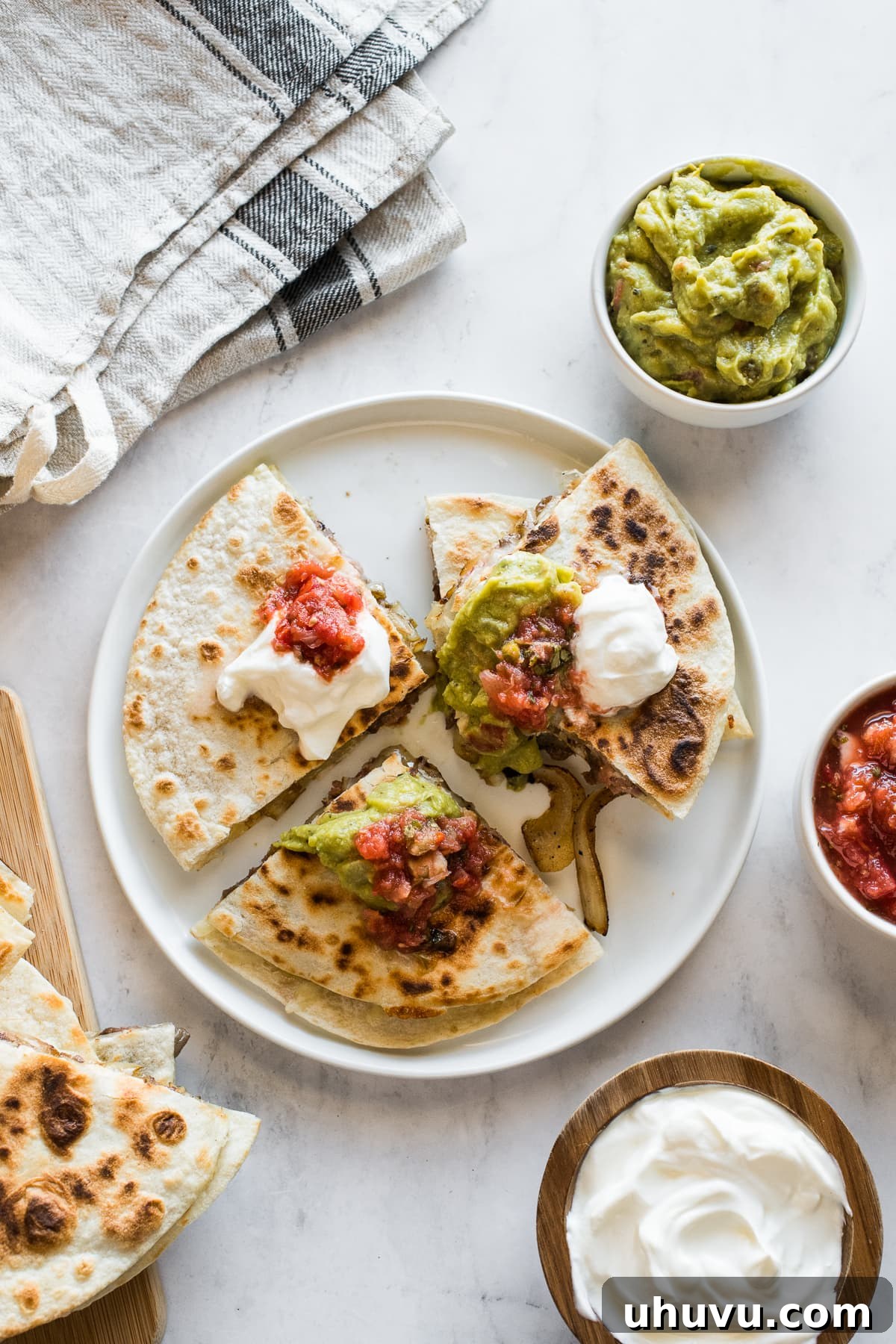 Gourmet Steak Quesadillas 5 A finished steak quesadilla topped generously with sour cream, salsa, and guacamole.