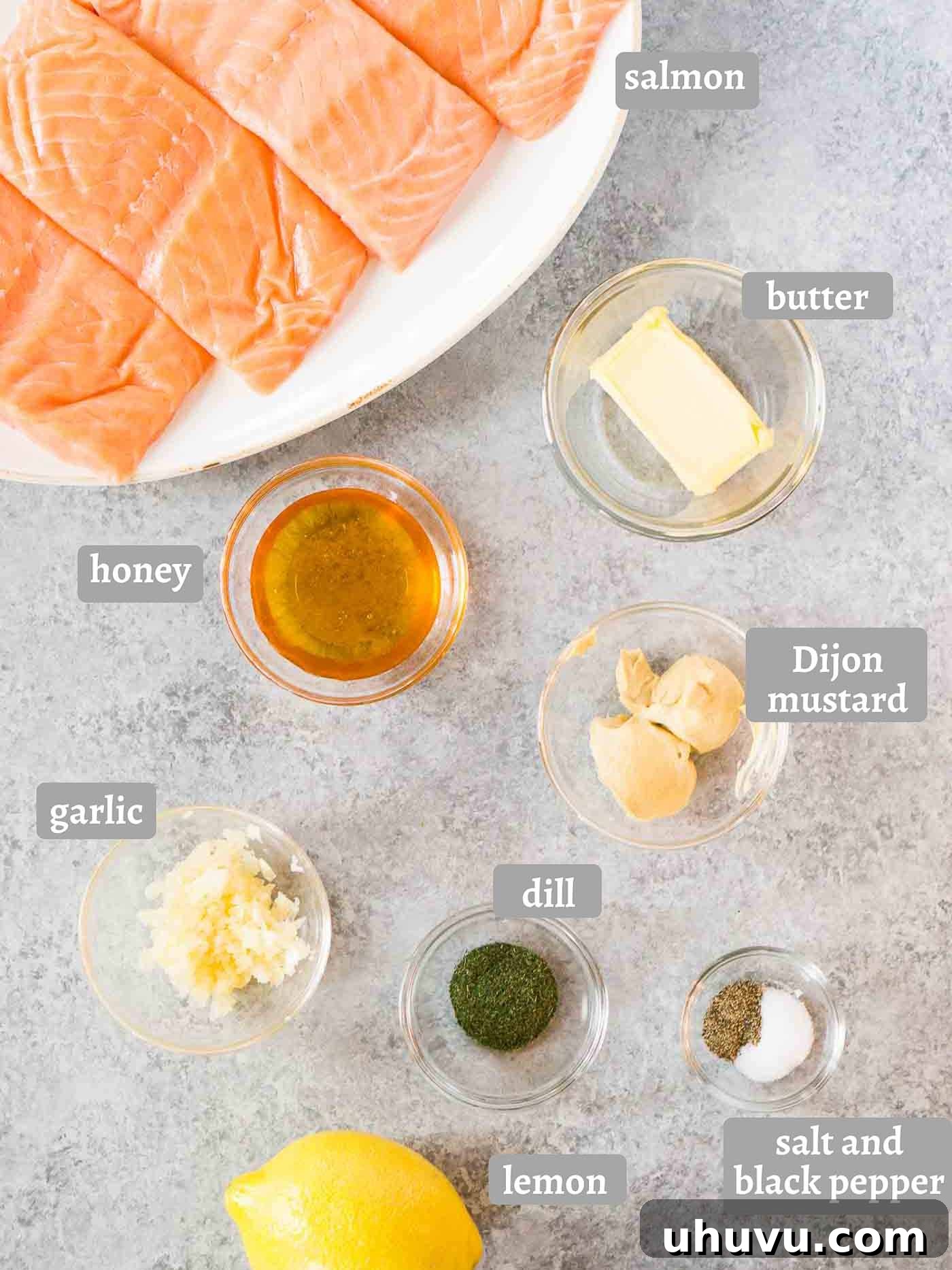 Quick Wholesome Honey Dijon Salmon Bake 4 A selection of fresh ingredients including salmon, lemons, garlic, dill, honey, and Dijon mustard, laid out on a wooden board for making honey dijon salmon in the oven