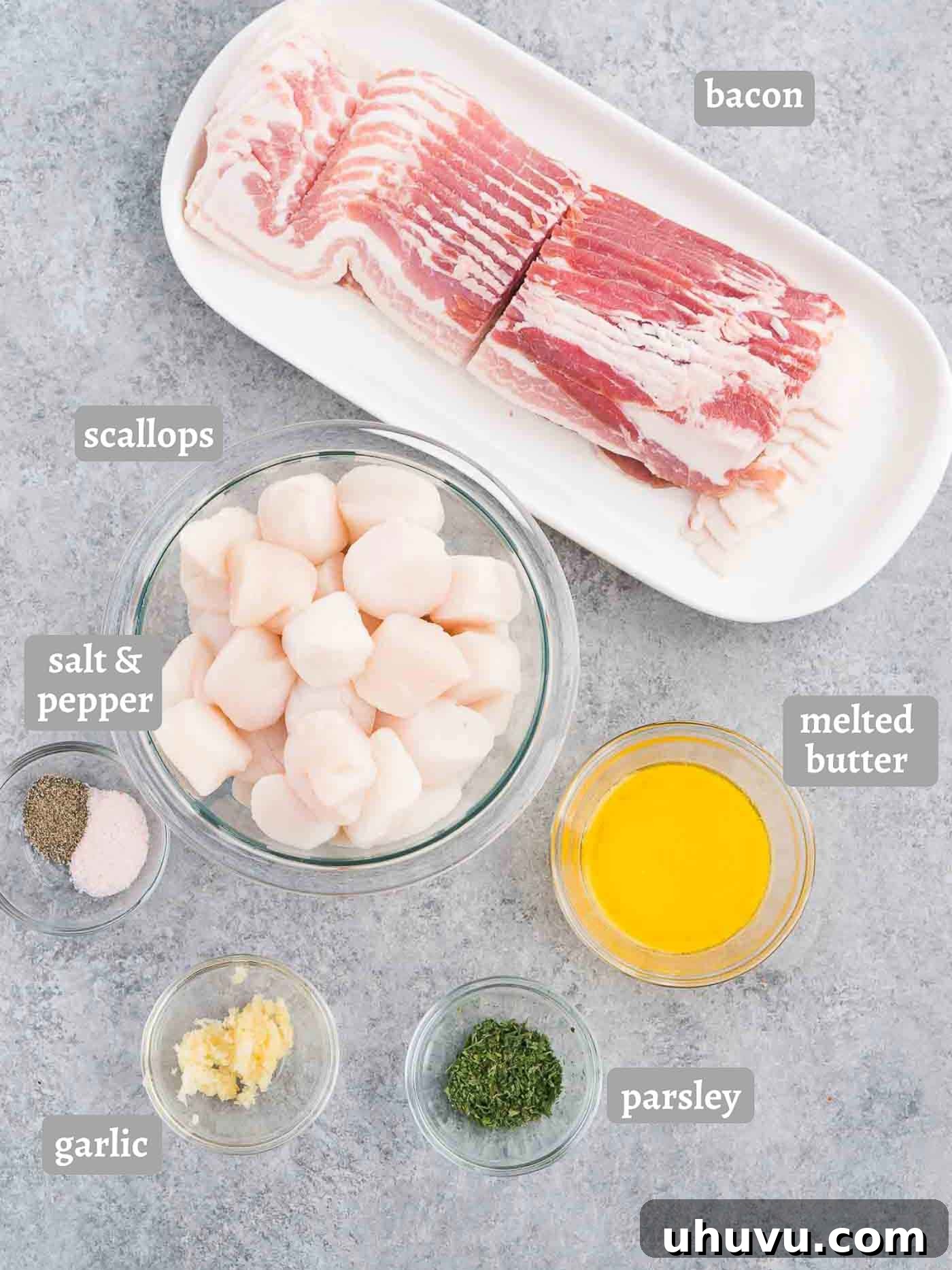 Smoky Bacon-Wrapped Scallop Bites 4 A flat lay image displaying all the fresh ingredients for making bacon wrapped scallops, including scallops, bacon, butter, garlic, parsley, and pepper jelly.
