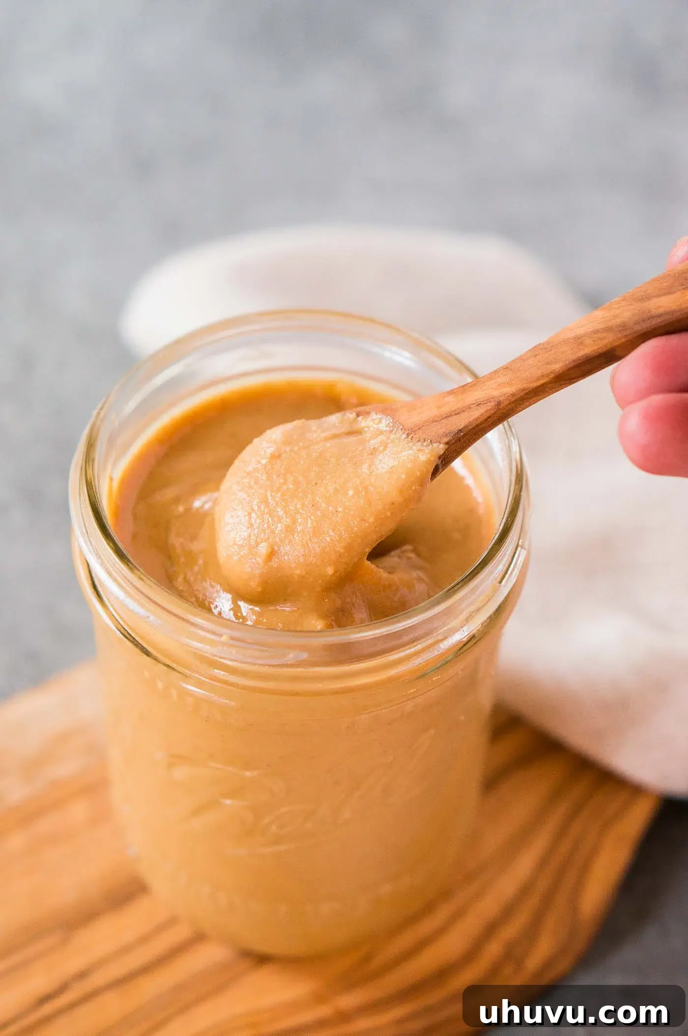 homemade peanut butter in a jar with a spoon