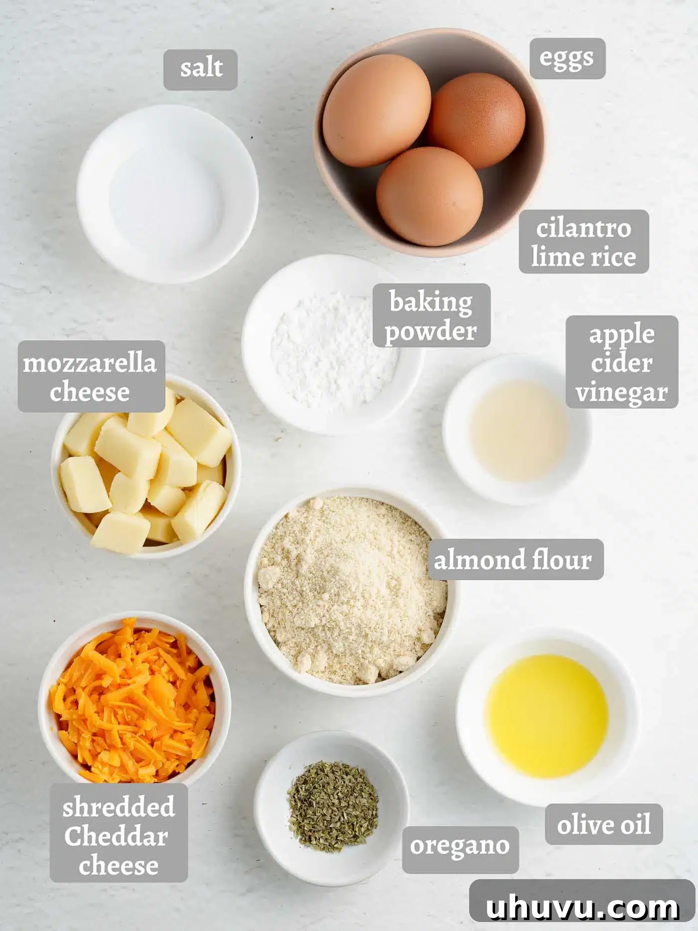 Assortment of fresh ingredients for making keto bagels, including almond flour, eggs, and cheeses.