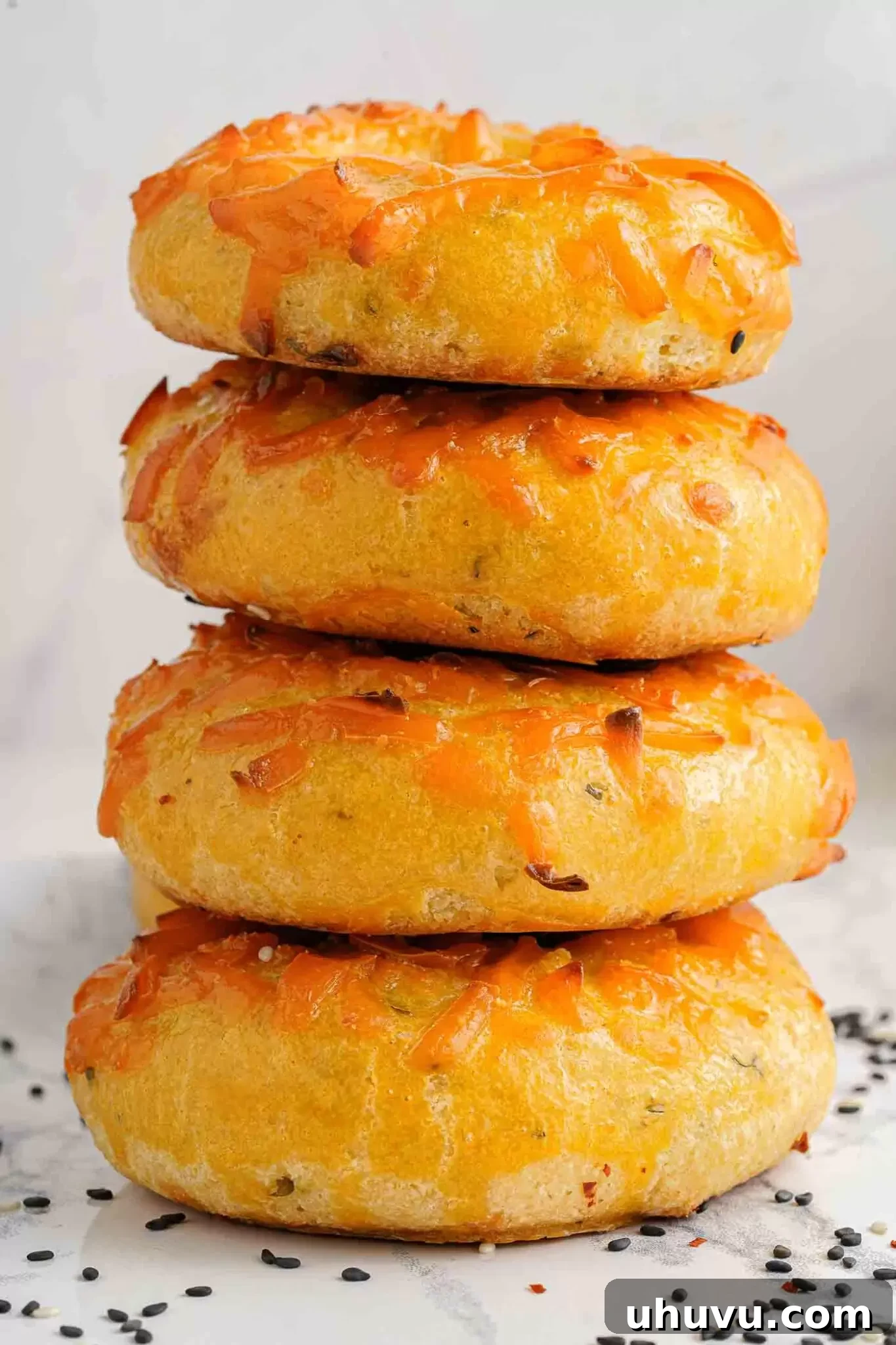 Stack of golden-brown keto cheese bagels, showcasing their delicious texture.