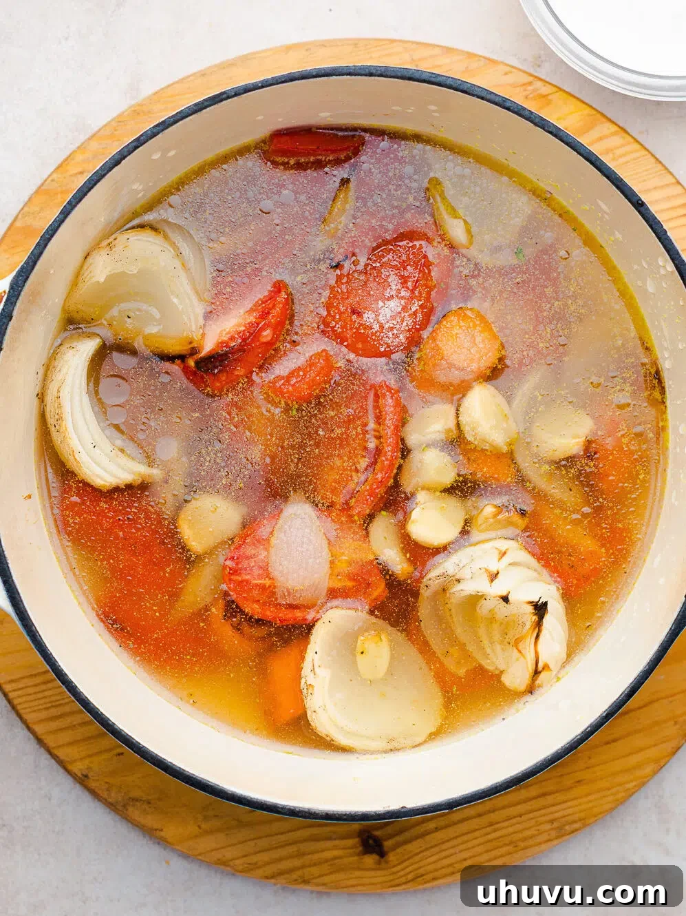 simmering roasted vegetables in a pot for soup