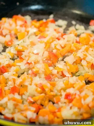 sauteeing vegetables in a skillet for moussaka