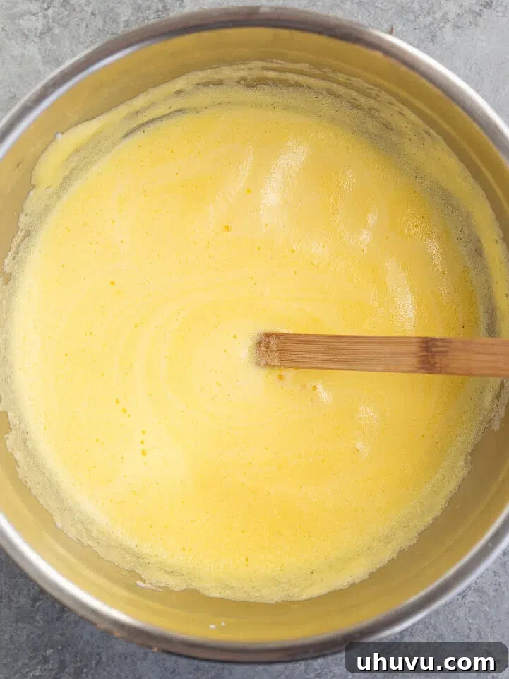making moussaka topping with yogurt eggs and cheese