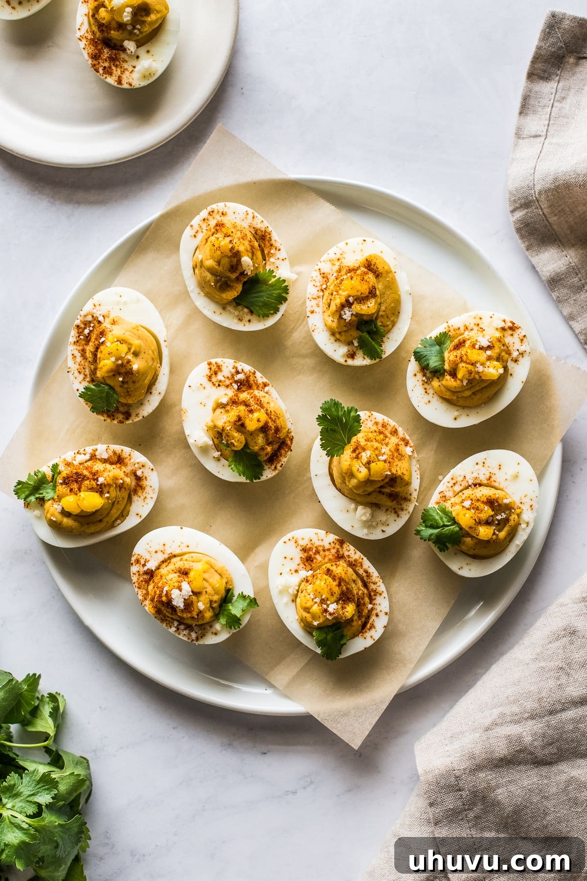 Elote Deviled Eggs 8 A beautiful serving platter overflowing with perfectly arranged Mexican street corn deviled eggs, ready to be enjoyed as a festive appetizer.