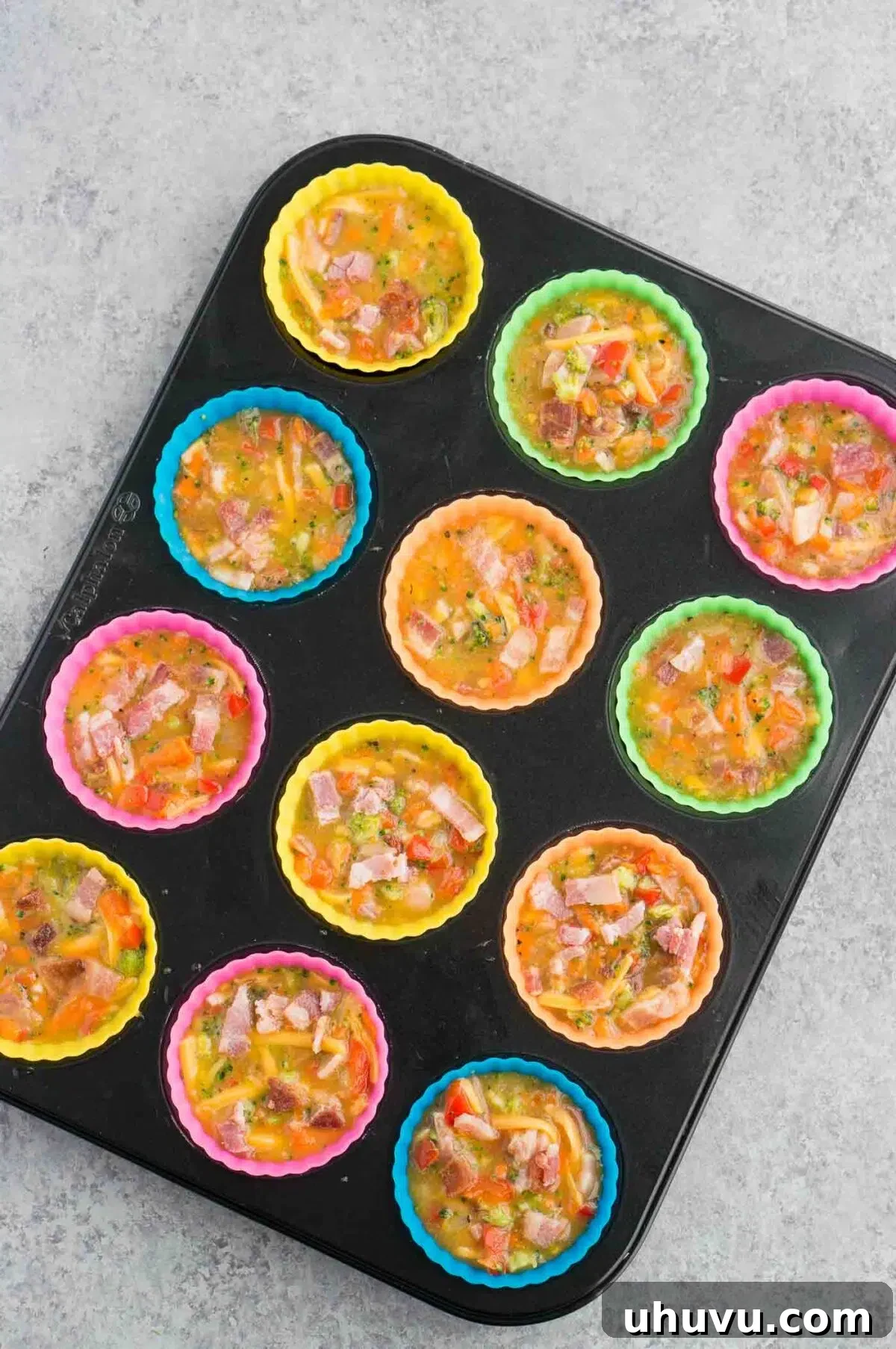 breakfast egg muffins mixture in a muffin pan, ready for baking