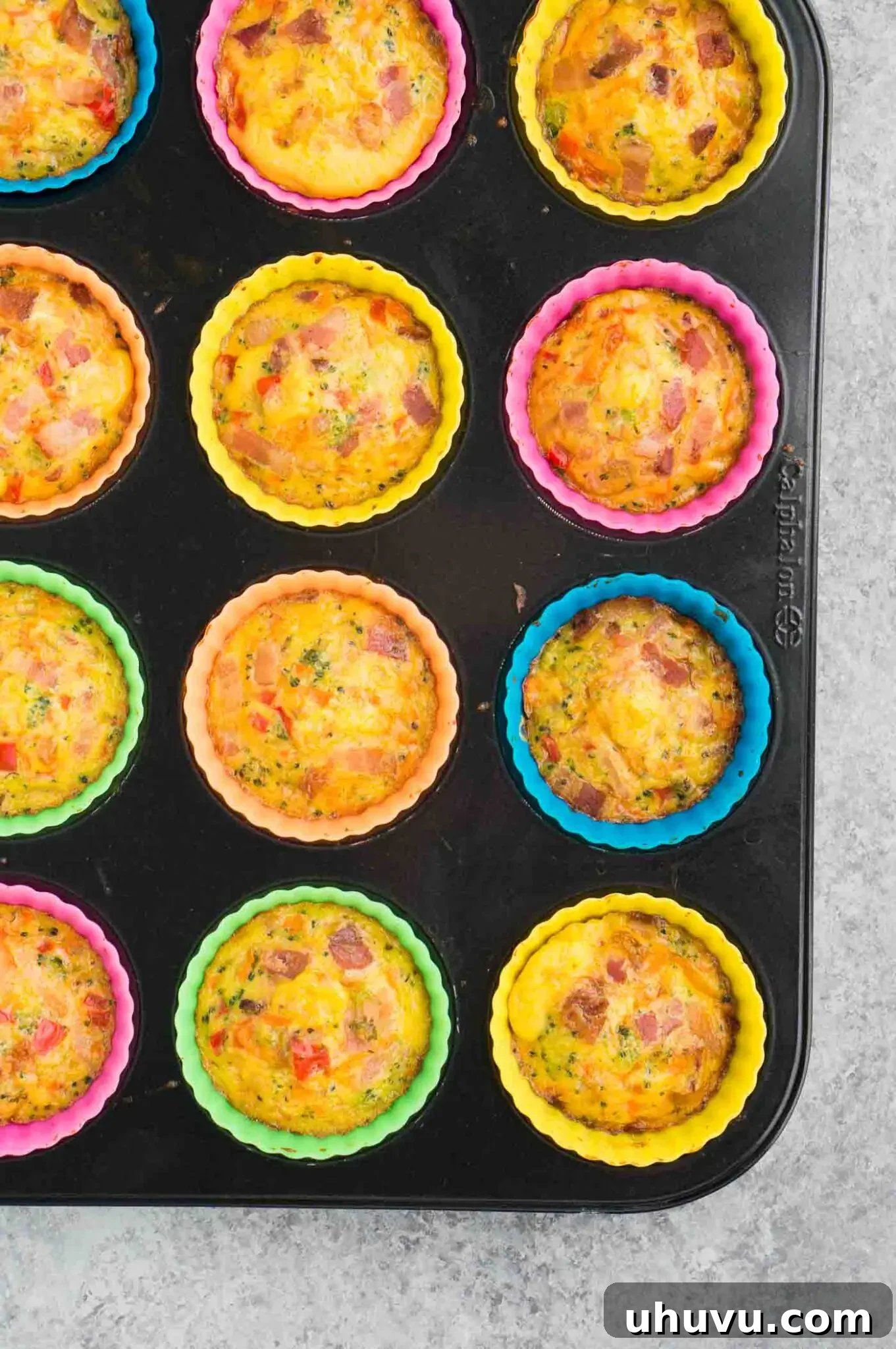 tray of golden brown egg breakfast muffins in a muffin tin