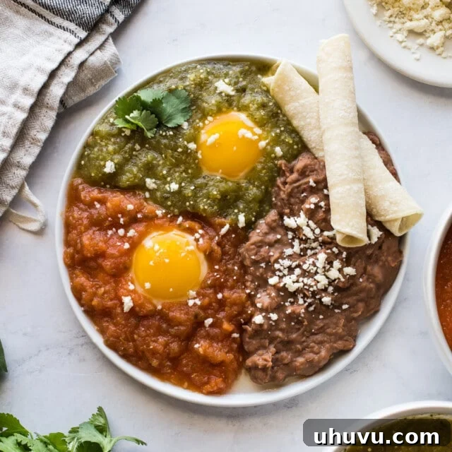 Huevos Divorciados on a plate served with refried beans.