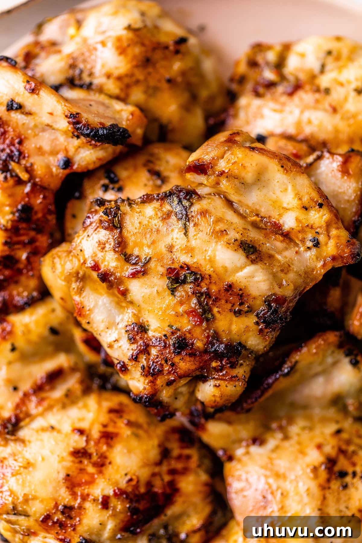 Vibrant Lime Chicken Marinade 4 Juicy grilled lime chicken thighs, perfectly charred and garnished with fresh lime wedges and cilantro.