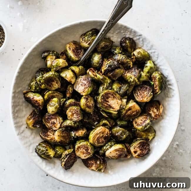 Caramelized Honey Balsamic Sprouts 8 Honey Balsamic Brussel Sprouts in a white bowl topped with sea salt.