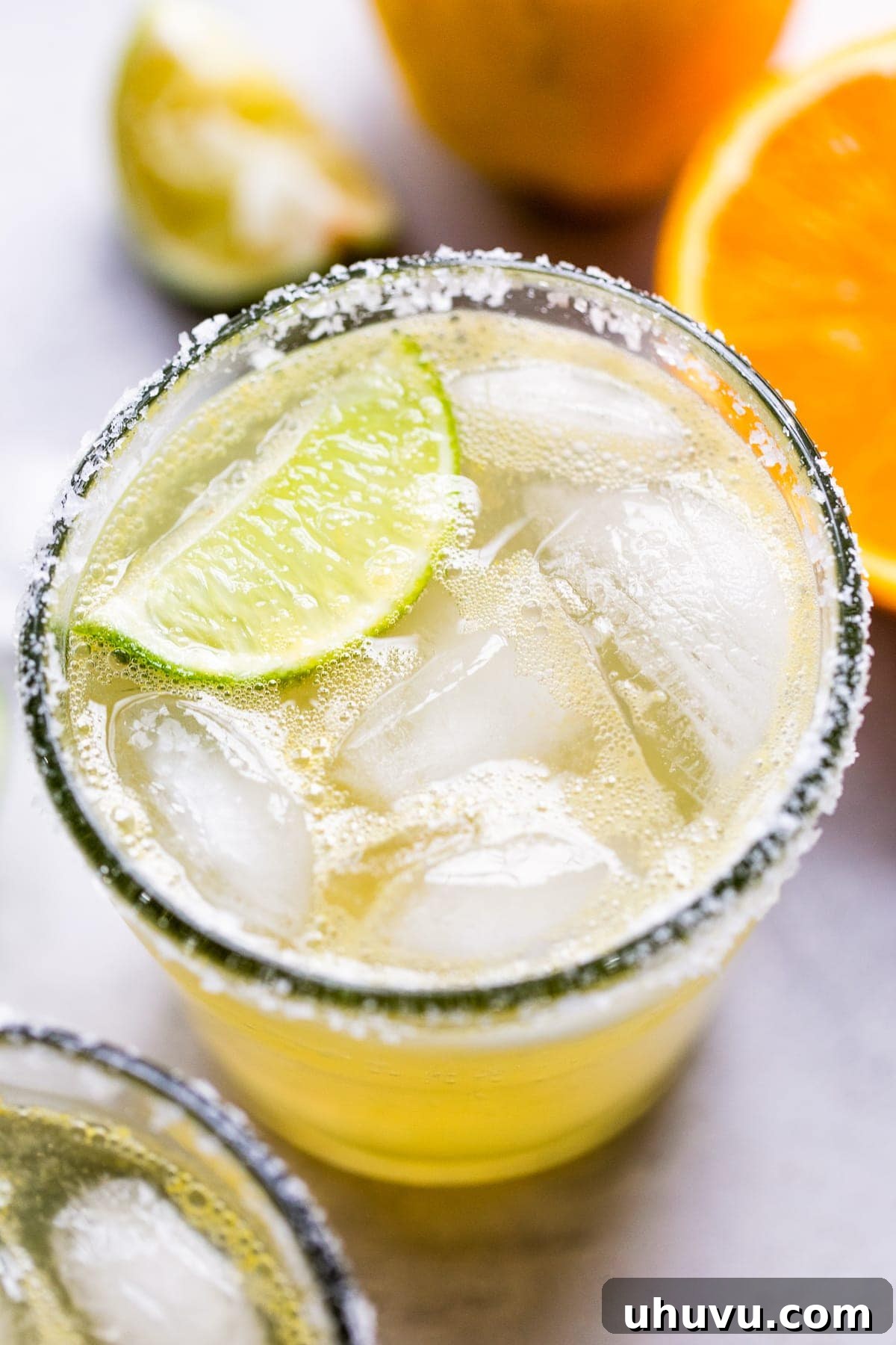 Mockarita 2 A classic virgin margarita cocktail in a glass with ice and a lime wedge, ready to be enjoyed.