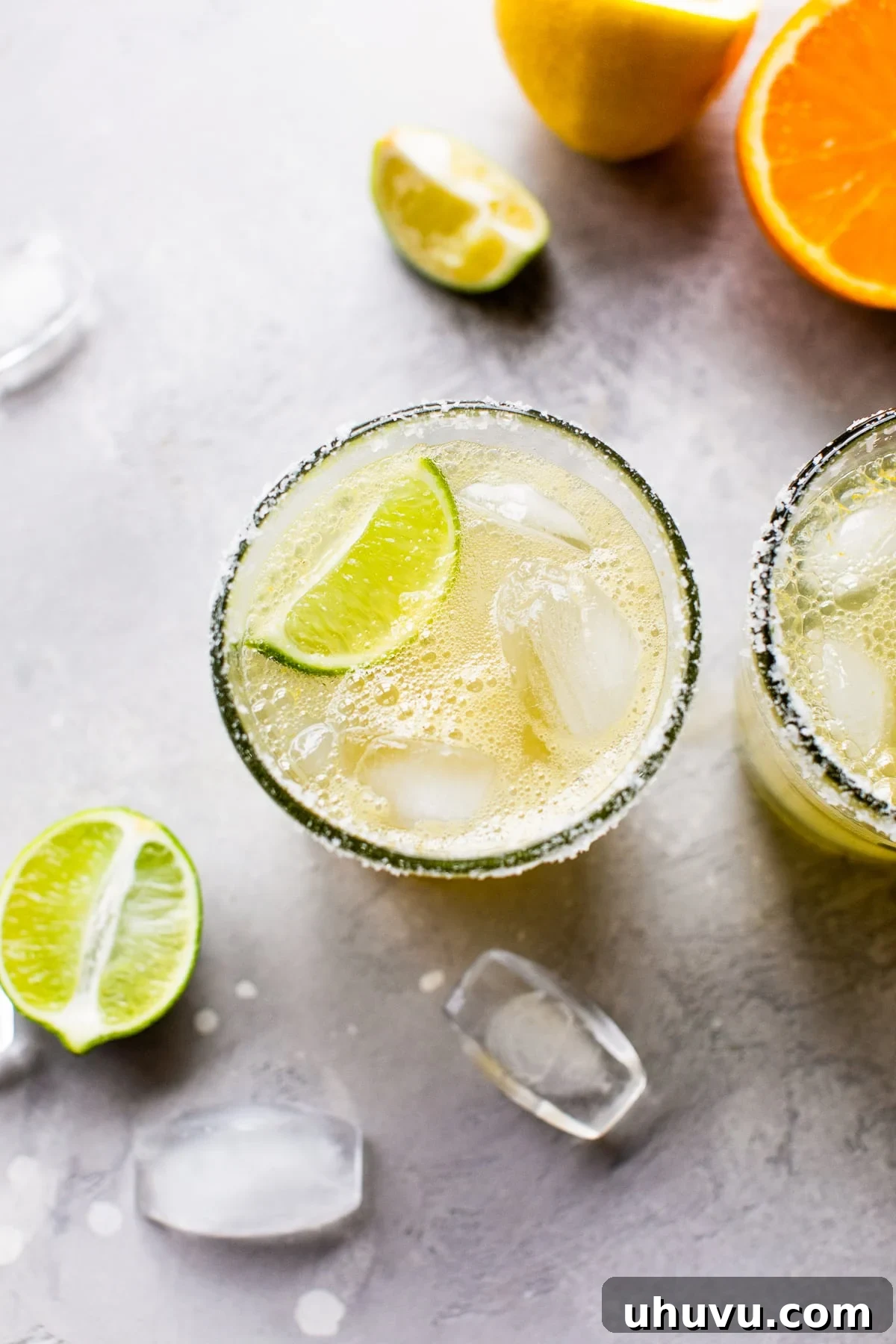 Mockarita 5 Virgin margarita mocktail on the rocks with a lime wedge, glistening and ready to be enjoyed.