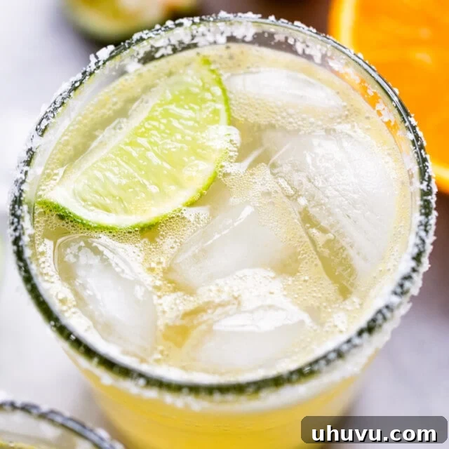 Mockarita 6 A classic virgin margarita cocktail in a glass with ice and a lime wedge.