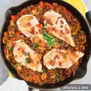 chicken and bacon added on top of cooked vegetables in a skillet