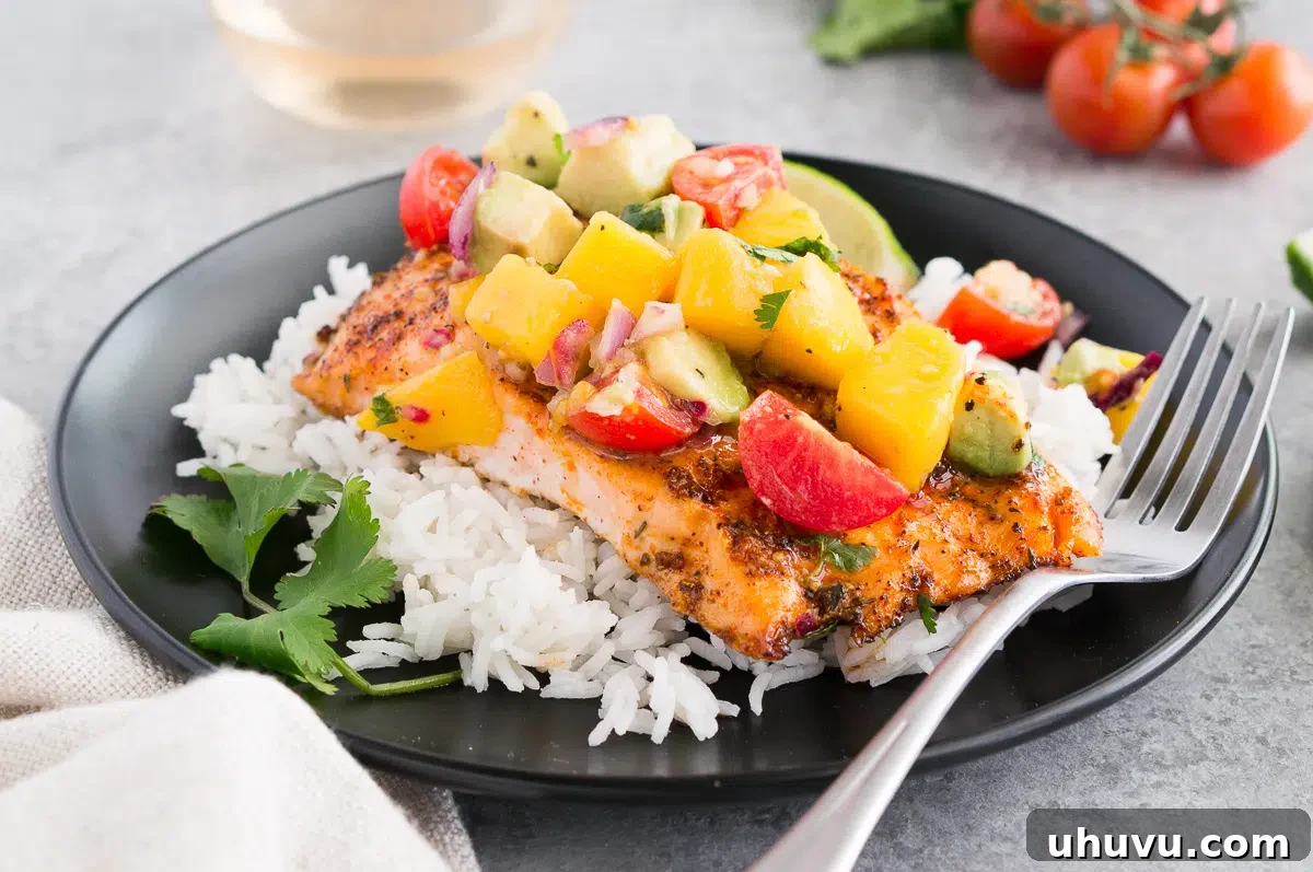 salmon with mango avocado salsa on a plate with rice