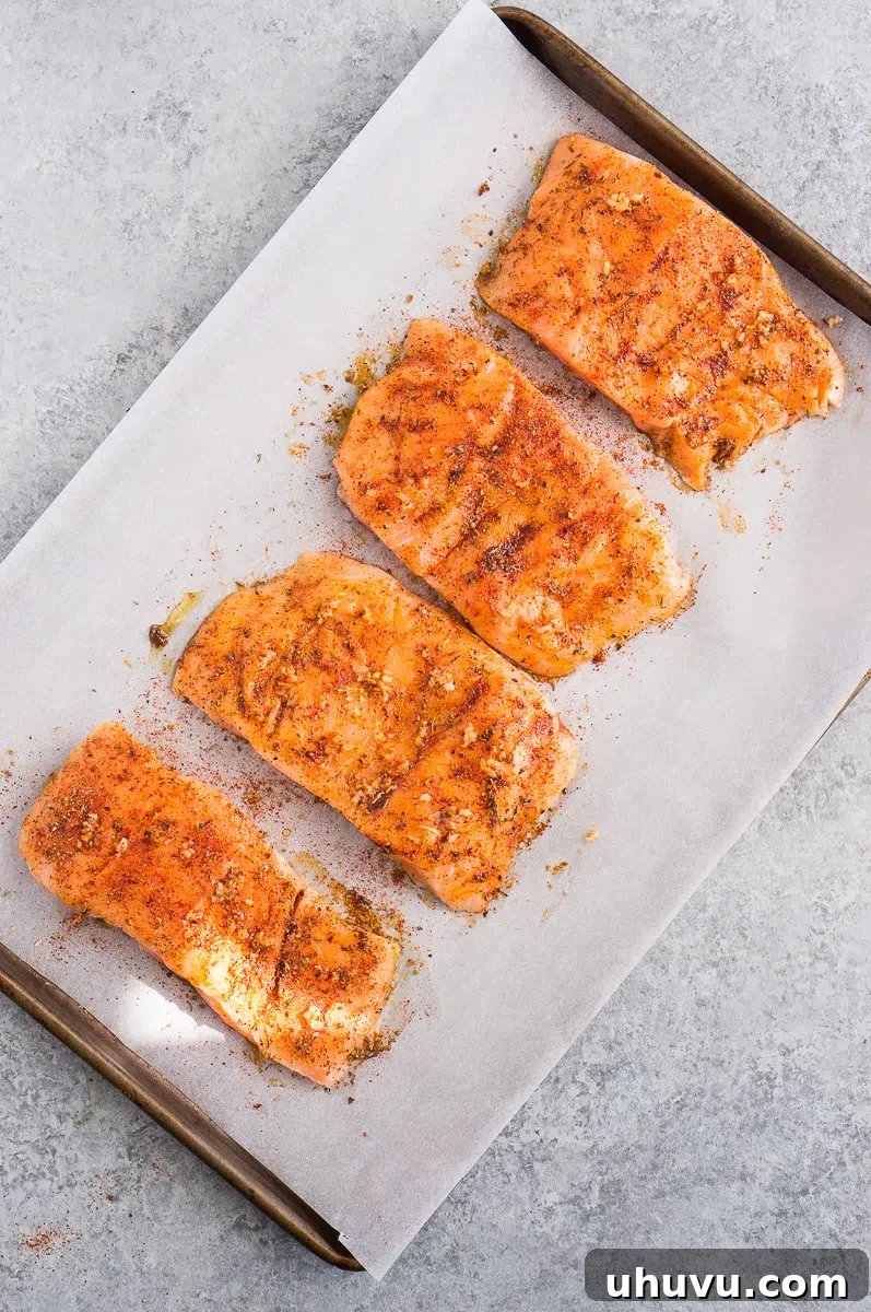 seasoned salmon on a baking sheet