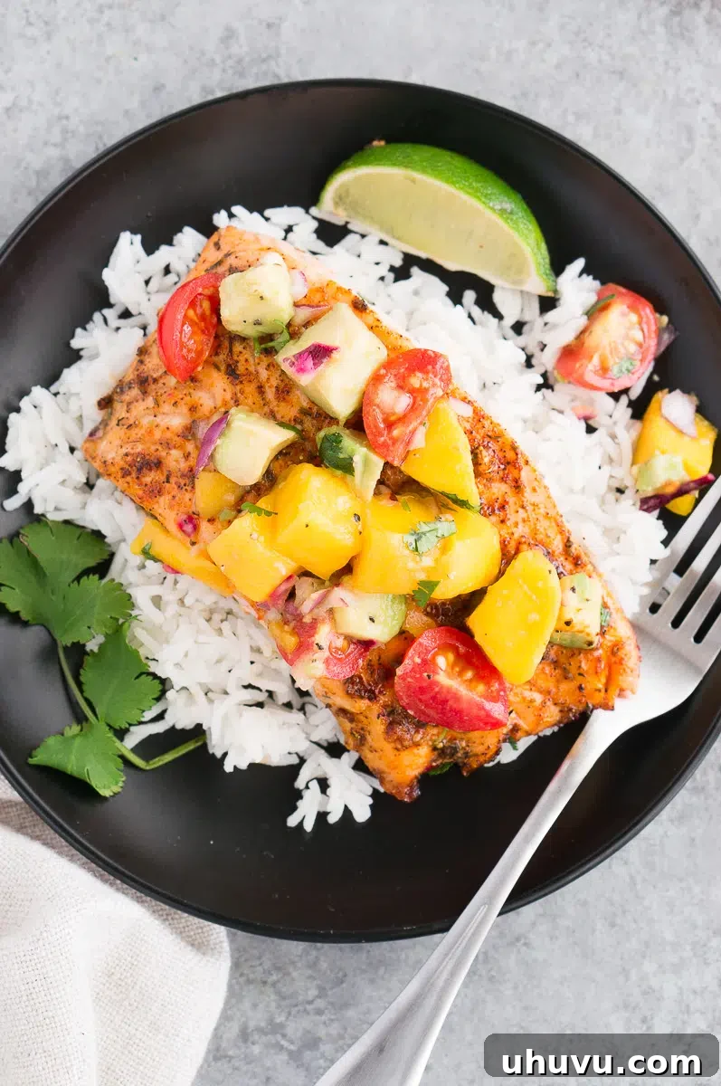 cooked salmon with mango avocado salsa on a plate