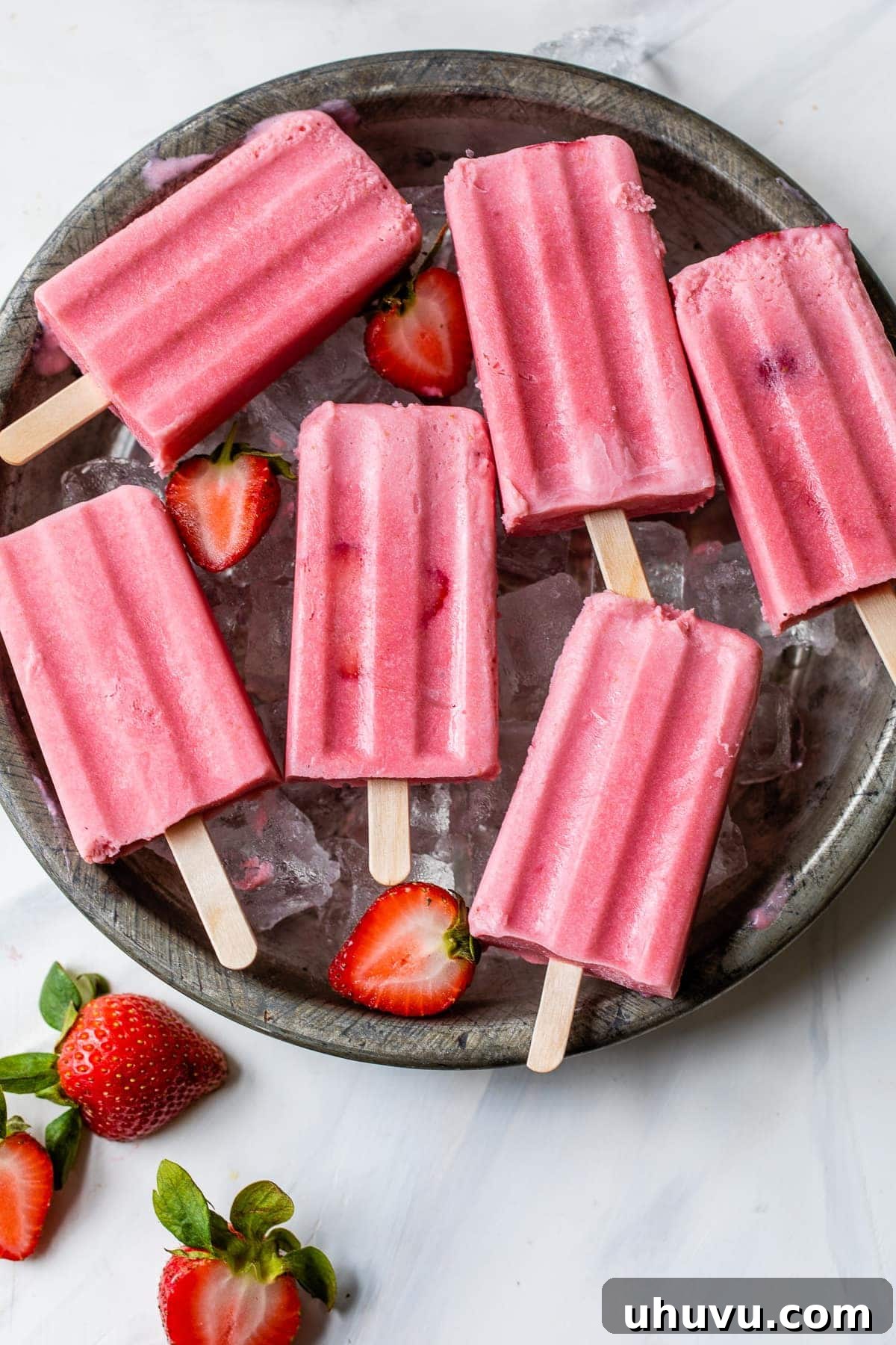 Strawberry Cloud Pops 2 Strawberries and cream popsicles ready to be eaten.