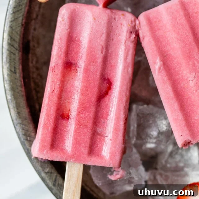 Strawberry Cloud Pops 7 Frozen strawberry paletas on ice.