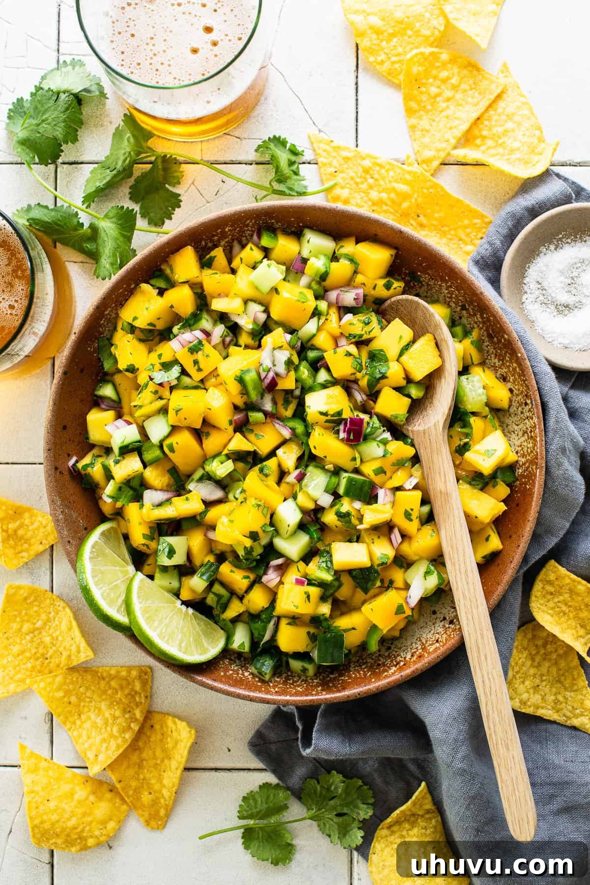 Tropical Mango Medley 5 Freshly prepared mango salsa, vibrant and colorful, served in a large decorative bowl on a rustic surface.