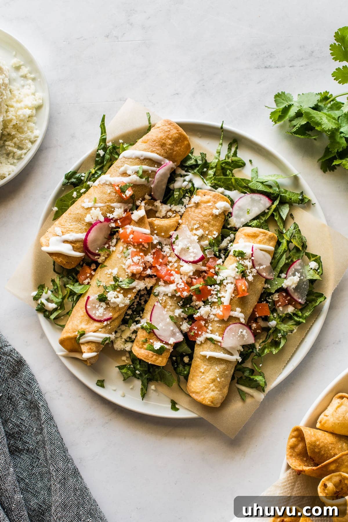 Golden Crispy Beef Taquitos 2 Beef taquitos topped with sour cream, avocado, and tomatoes.