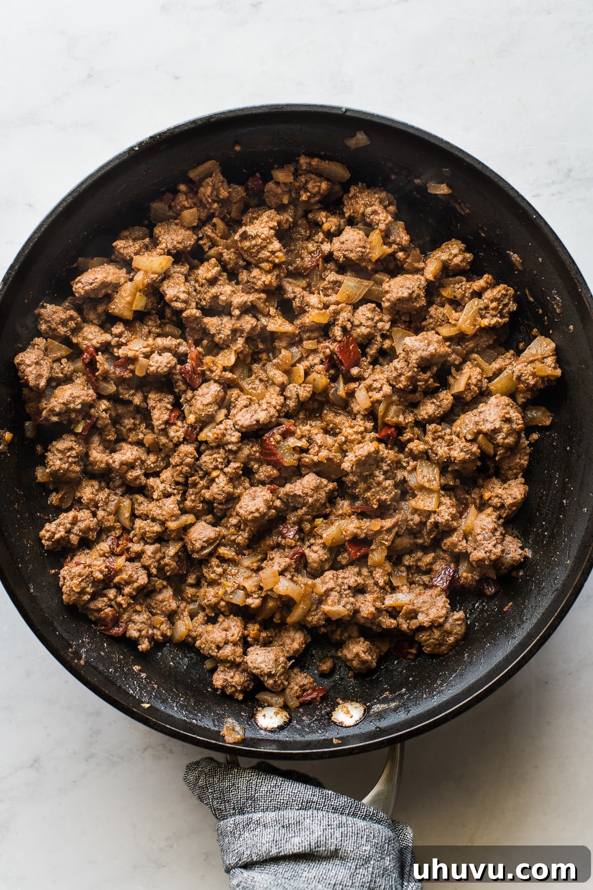 Golden Crispy Beef Taquitos 3 Ground beef mixture for beef taquitos in a skillet.