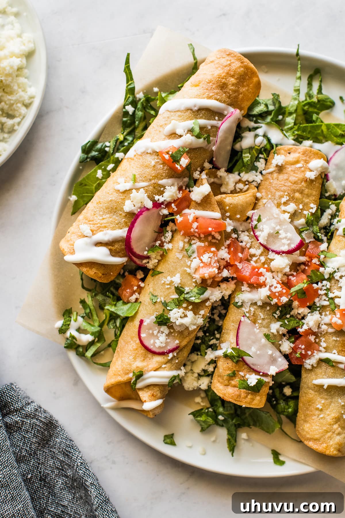 Golden Crispy Beef Taquitos 6 Beef taquitos on a bed of shredded lettuce.