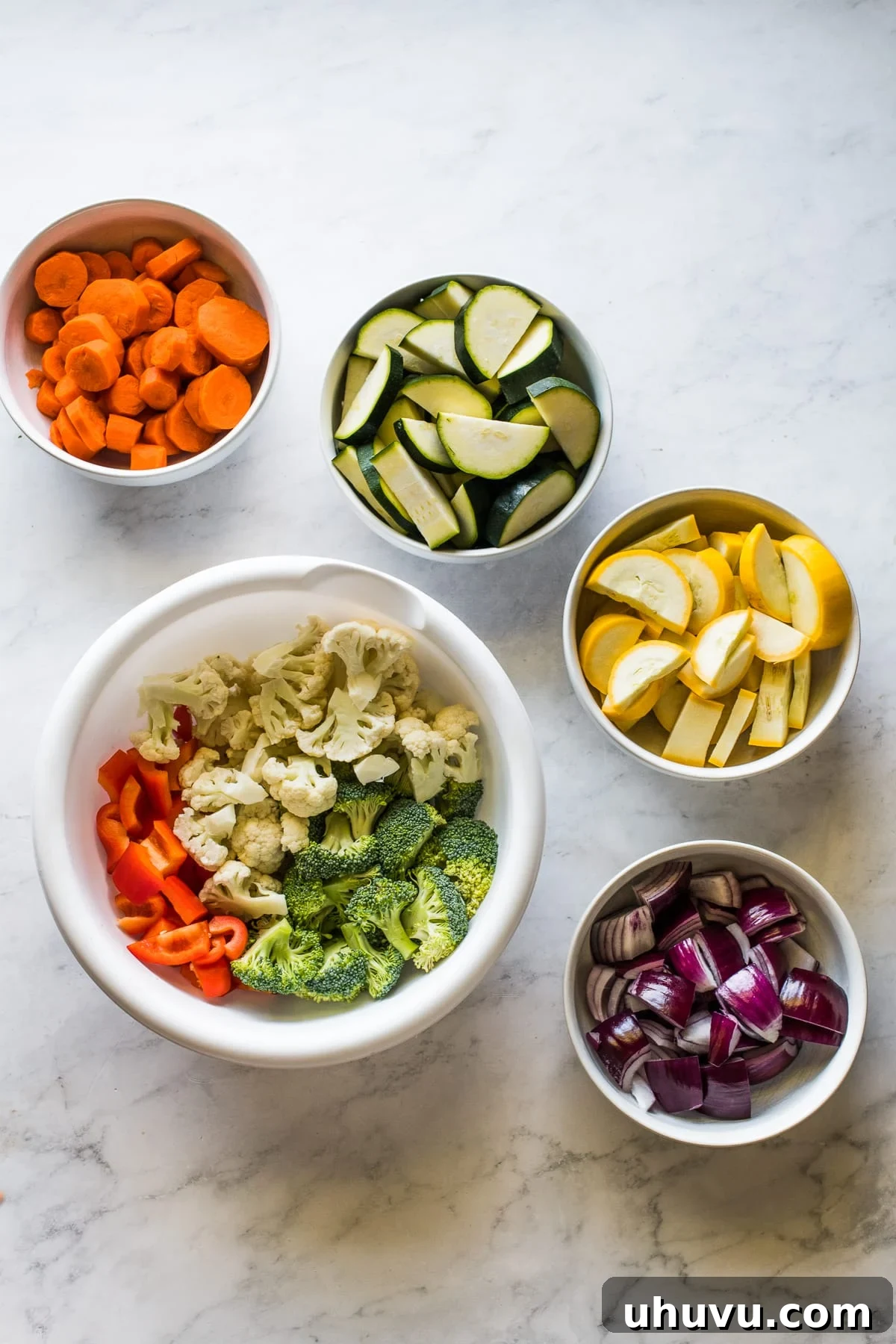 Fiesta Roasted Vegetables 3 Diced vegetables in bowls ready to be roasted.