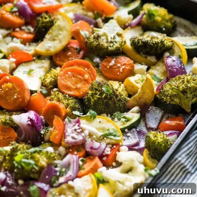 Fiesta Roasted Vegetables 7 Roasted vegetables on a sheet pan topped with cilantro and cotija cheese.