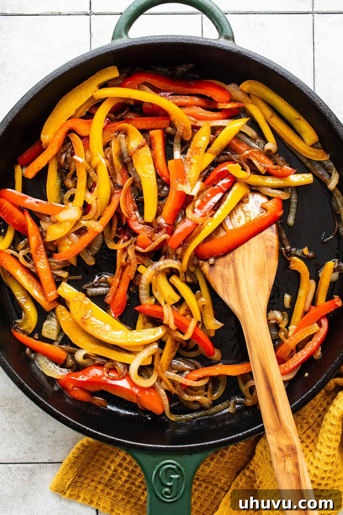Sizzling Chicken Fajitas 5 Vibrant bell peppers and thinly sliced onions sautéing in a large cast iron skillet.